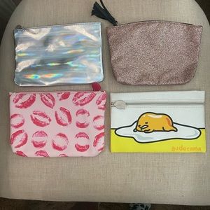 Four Ipsy cosmetic cases. New
